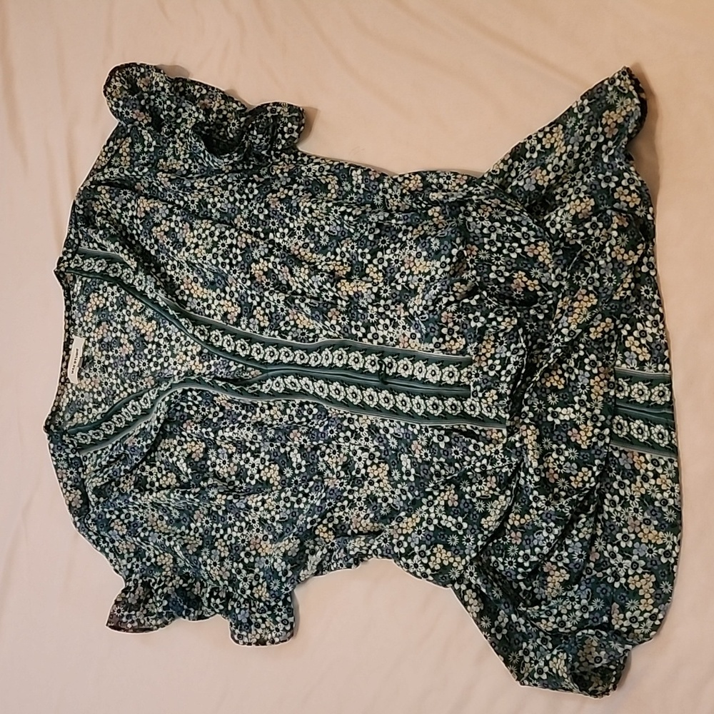 Green flowered top, elastic and tie in back.